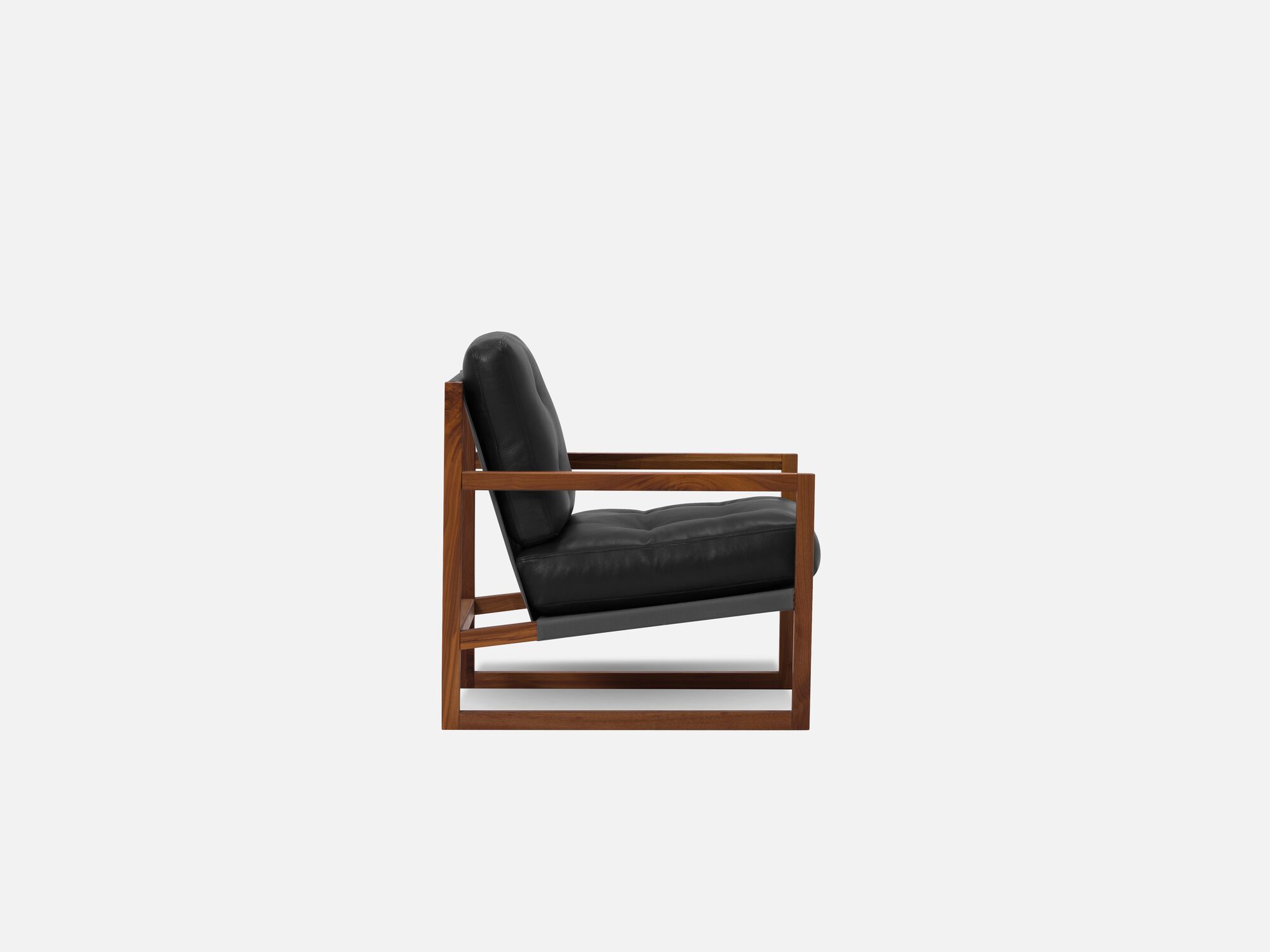 Side view of black and walnut tufted lounge chair